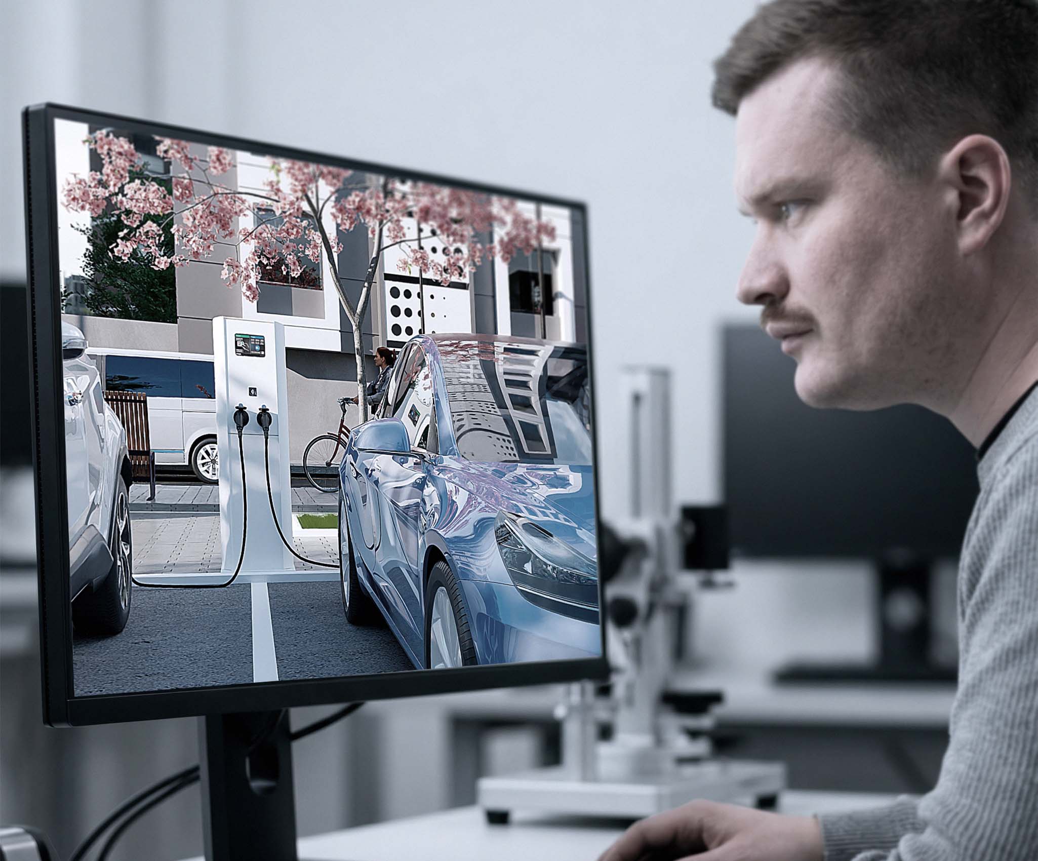 Engineer van ILITAS beoordeelt een EV-render op een scherm in moderne werkomgeving